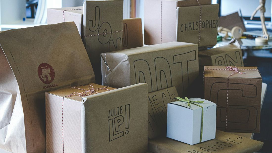 Handmade orders wrapped in brown kraft paper and twine, ready to post to customers